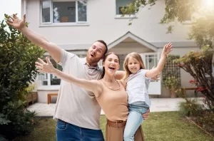 happy family outside of a home